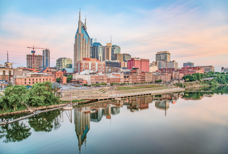 Image is of the Nashville skyline in low light, concept of the best business meeting spots near Music Row