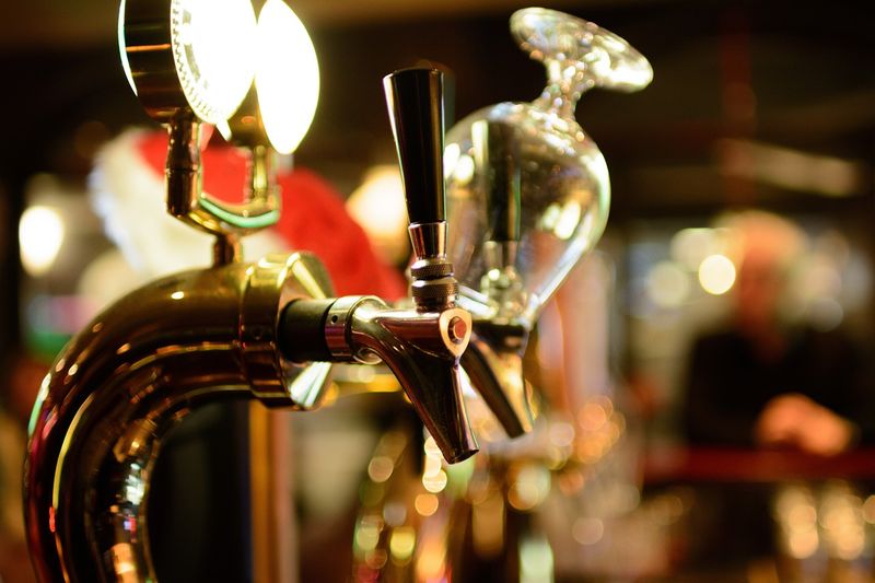 Image is of beer taps in a bar, concept of best Nashville breweries and distilleries.