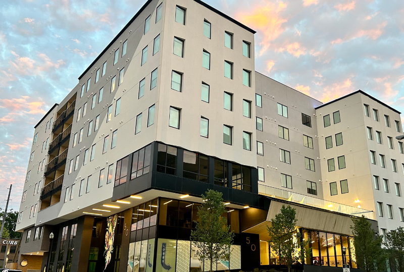 Image is of an exterior view of Motif on Music Row at dusk, concept of suites for business travel