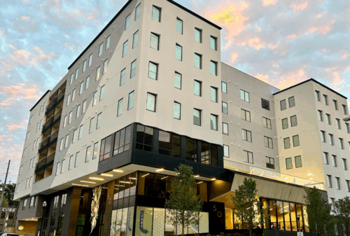 Image is of the exterior of Motif on Music Row in Nashville Tennessee at dusk, concept of the features of the suites at Motif